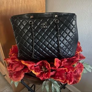 This Chanel bag is black w/blk chain, quality made of lamb skin
